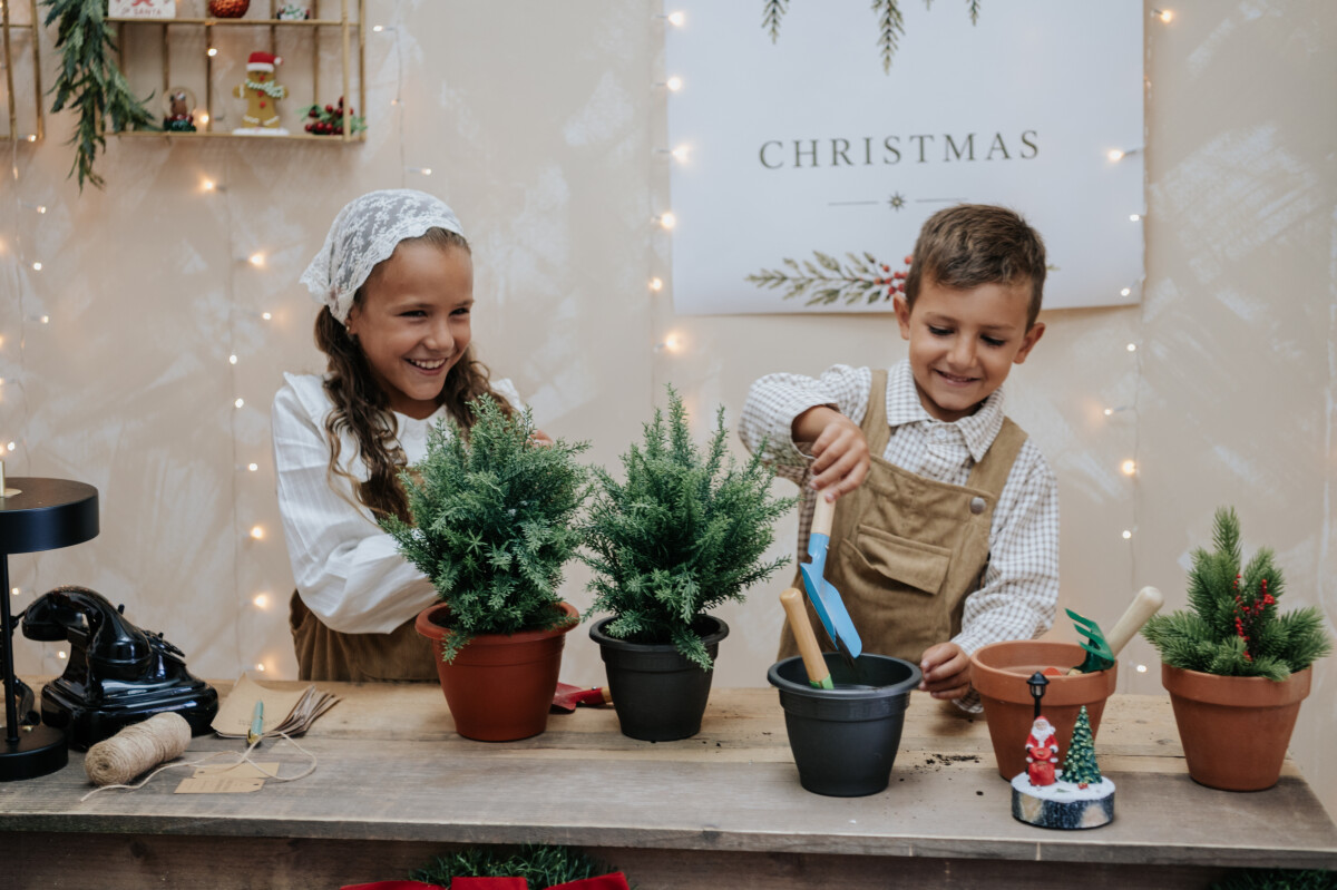 Los peques juegan entre macetas y flores de Navidad
